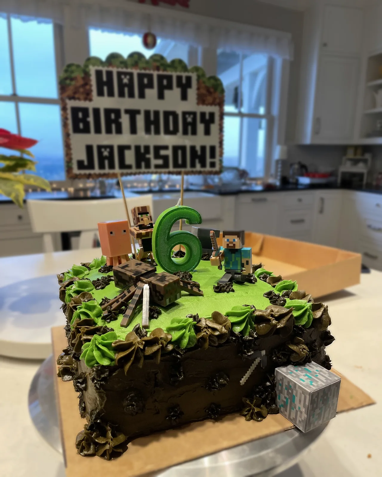 Minecraft themed birthday cake with character toppers