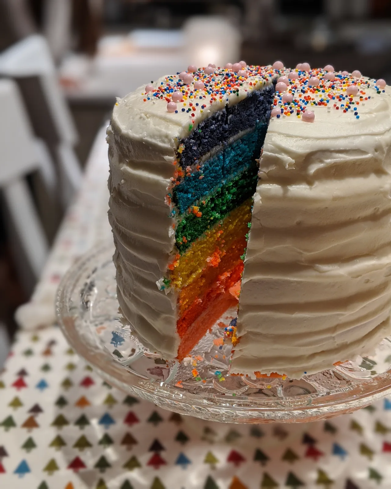 Rainbow layer cake slice with sprinkles
