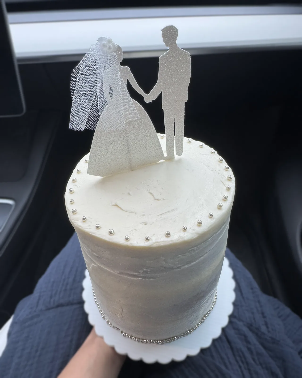 Minimal wedding cake with bride and groom topper